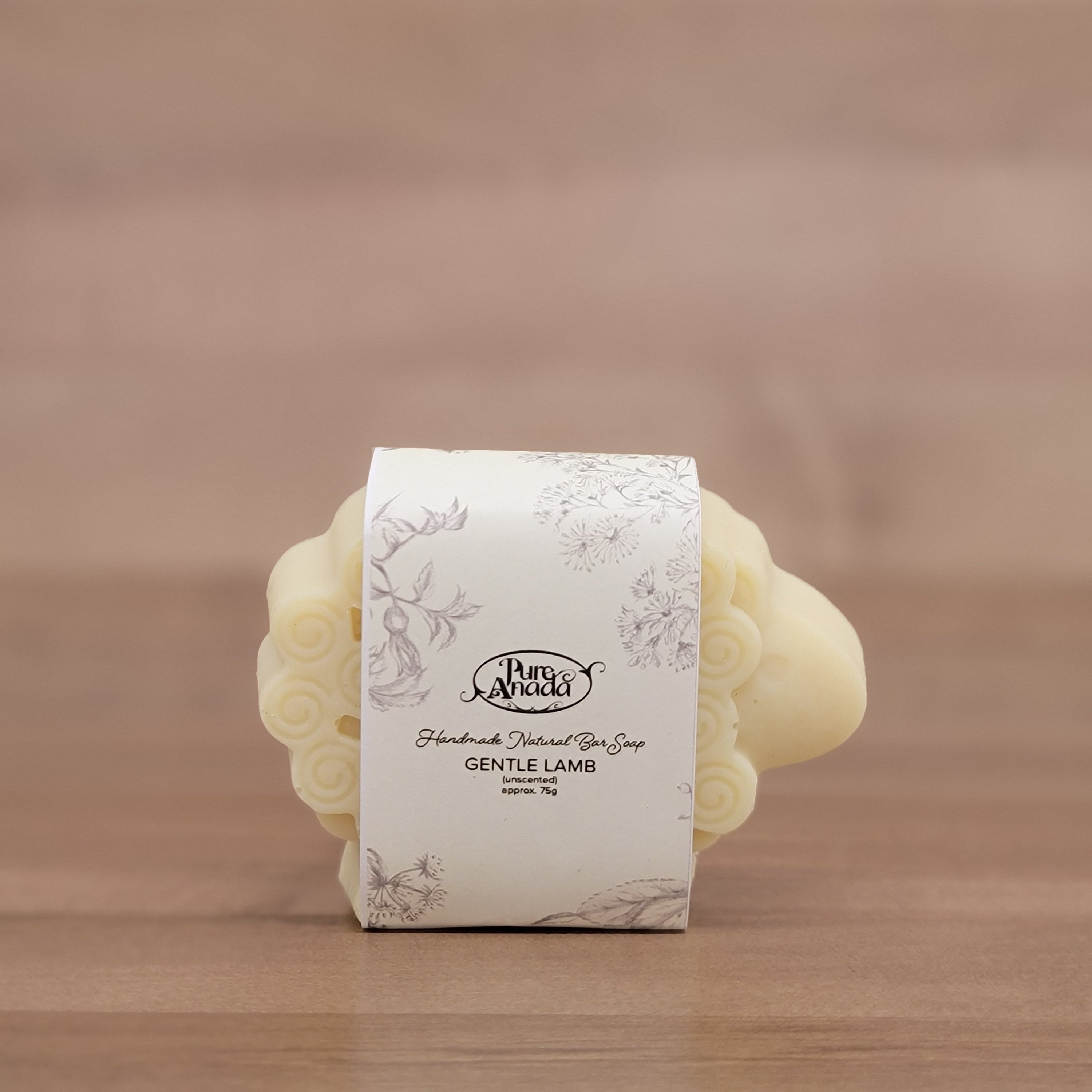 Bath bombs wrapped in a decorative paper label on a wooden surface